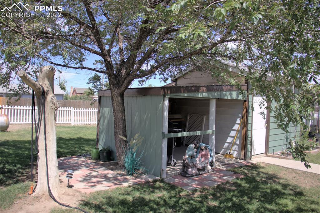 728 Graphite Street Florence, CO 81226 - Photo 23 of 30 a view of a chair and table in backyard of the house
