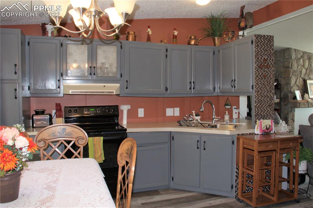 728 Graphite Street Florence, CO 81226 - Photo 7 of 30 a kitchen with stainless steel appliances granite countertop a stove and cabinets