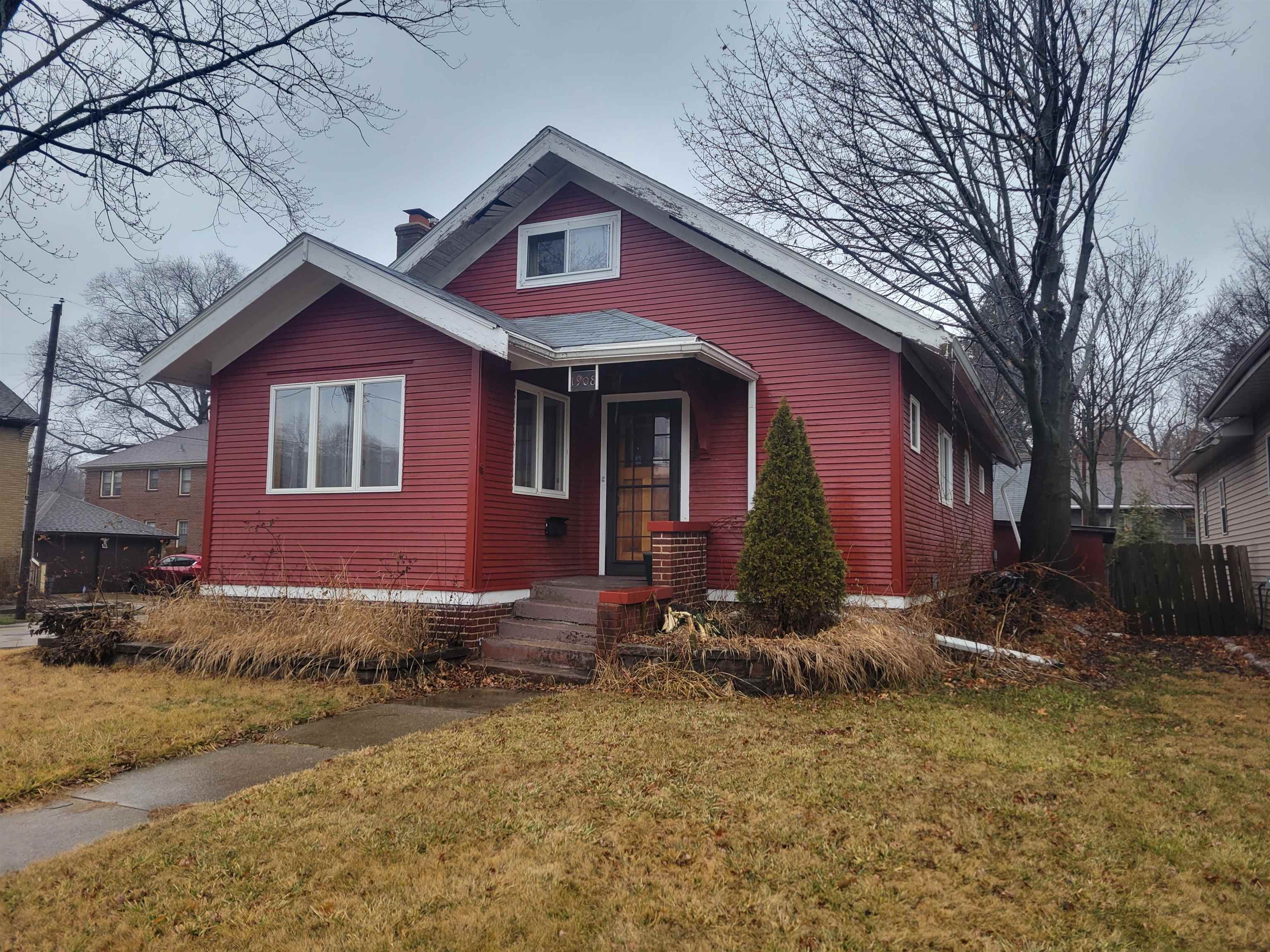 1908 Rural Street Rockford, IL 61107 - Photo 1 of 19 a front view of a house with a yard