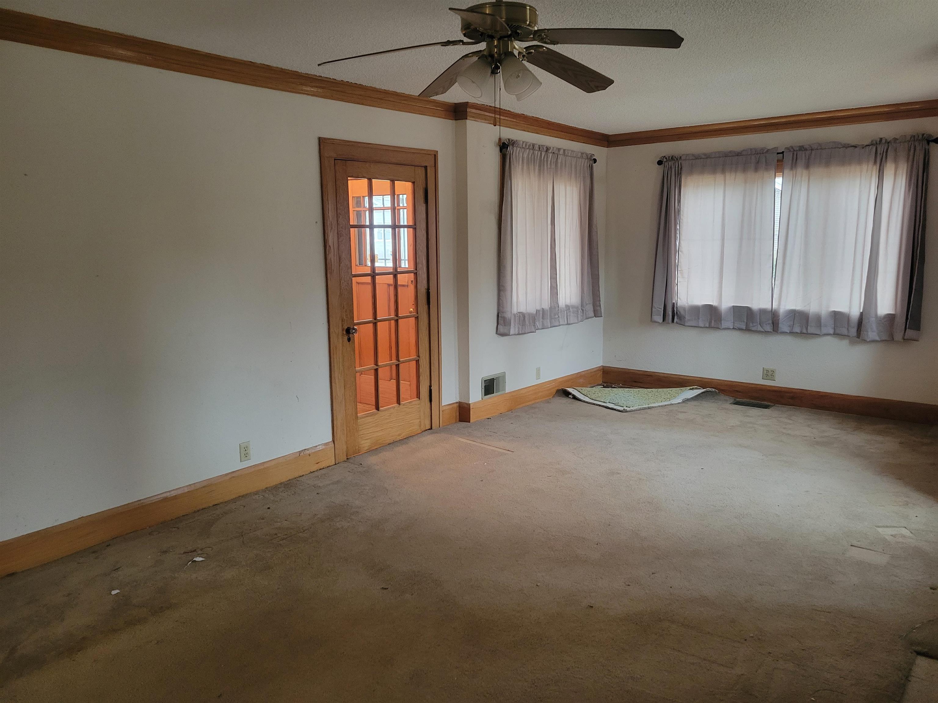 1908 Rural Street Rockford, IL 61107 - Photo 5 of 19 an empty room with windows and fan