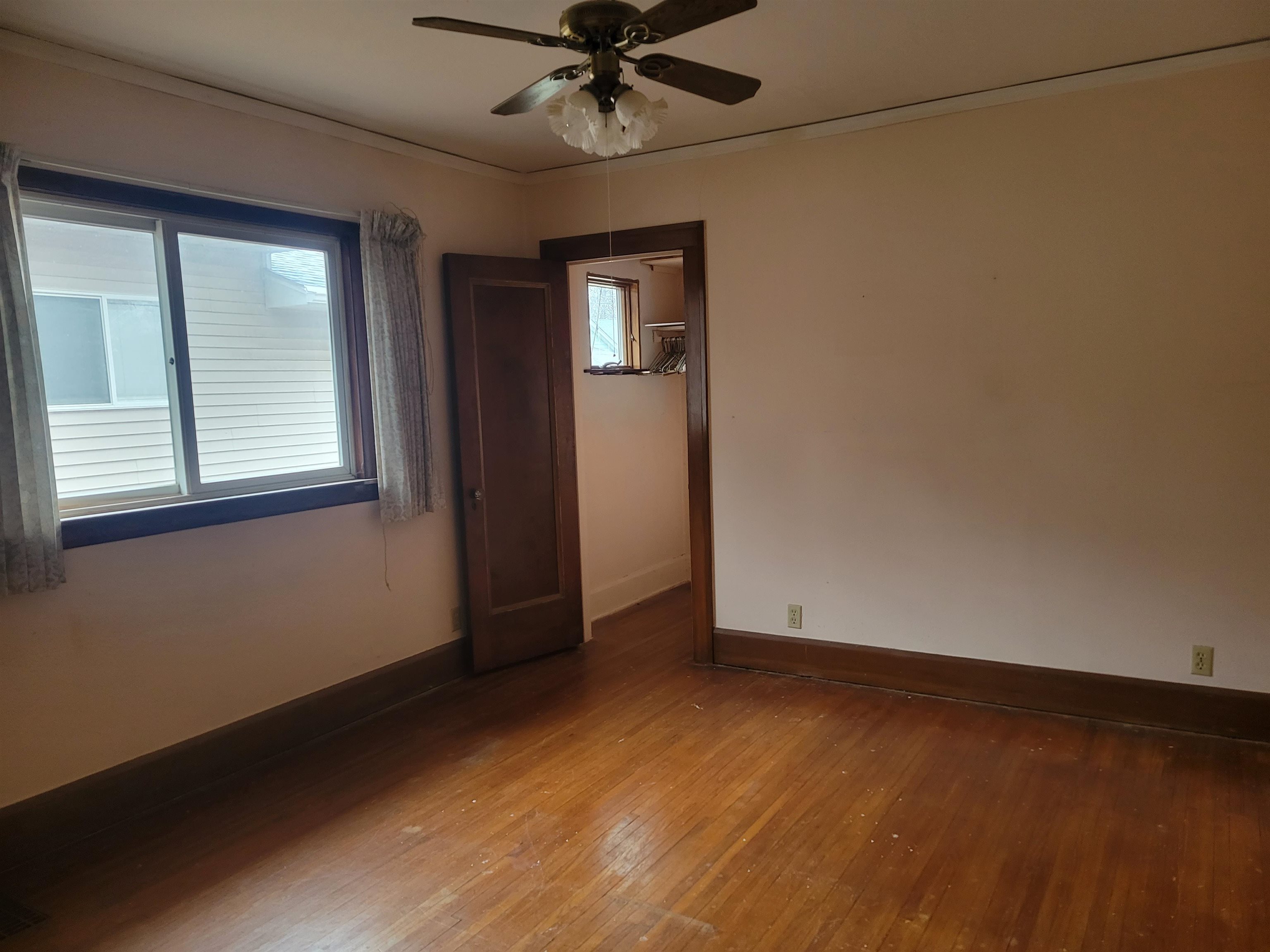 1908 Rural Street Rockford, IL 61107 - Photo 10 of 19 an empty room with wooden floor fan and windows