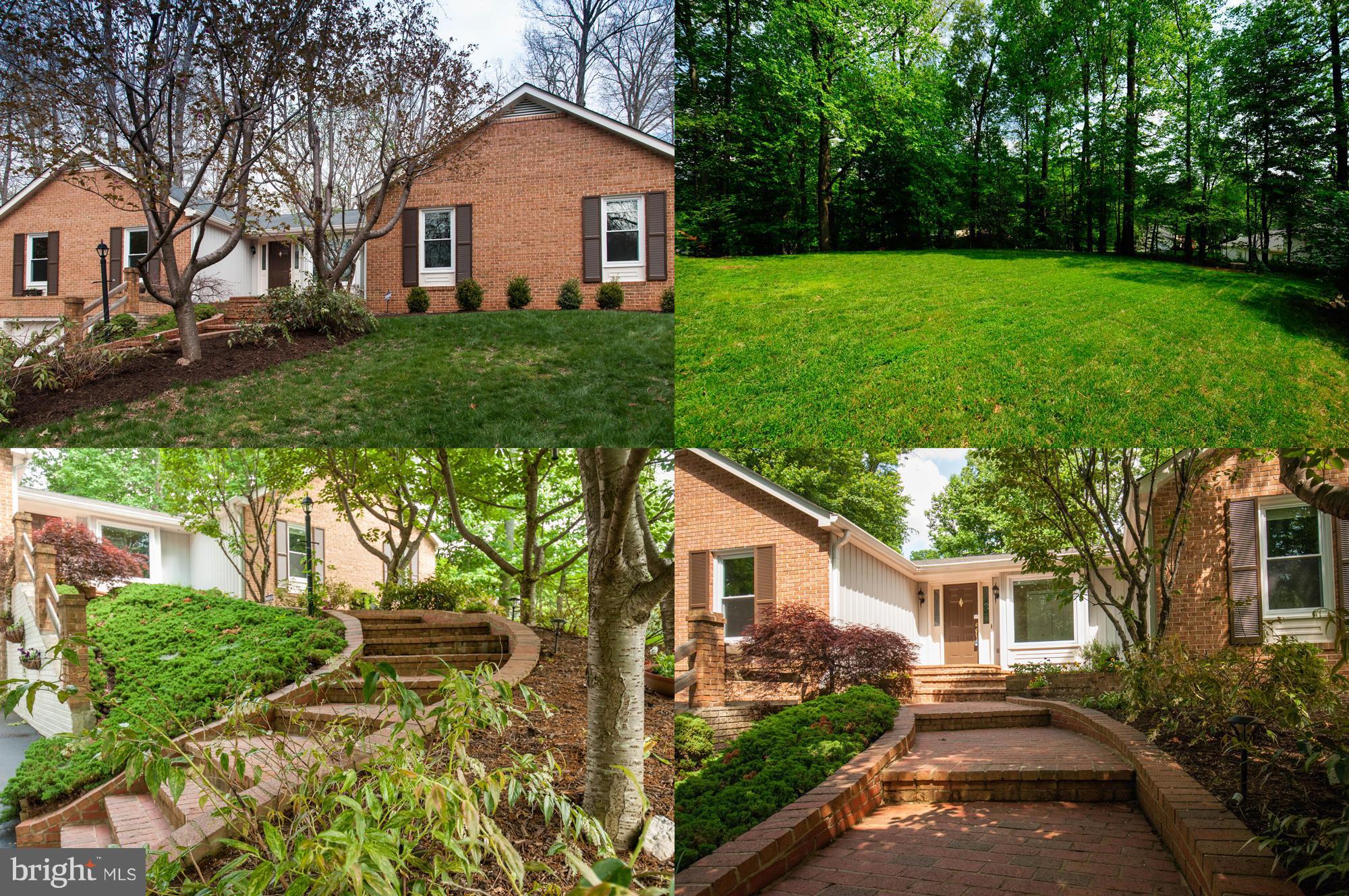 11662 Havenner Road Fairfax Station, VA 22039 - Photo 1 of 30 a view of a yard in front of a house with plants and large trees
