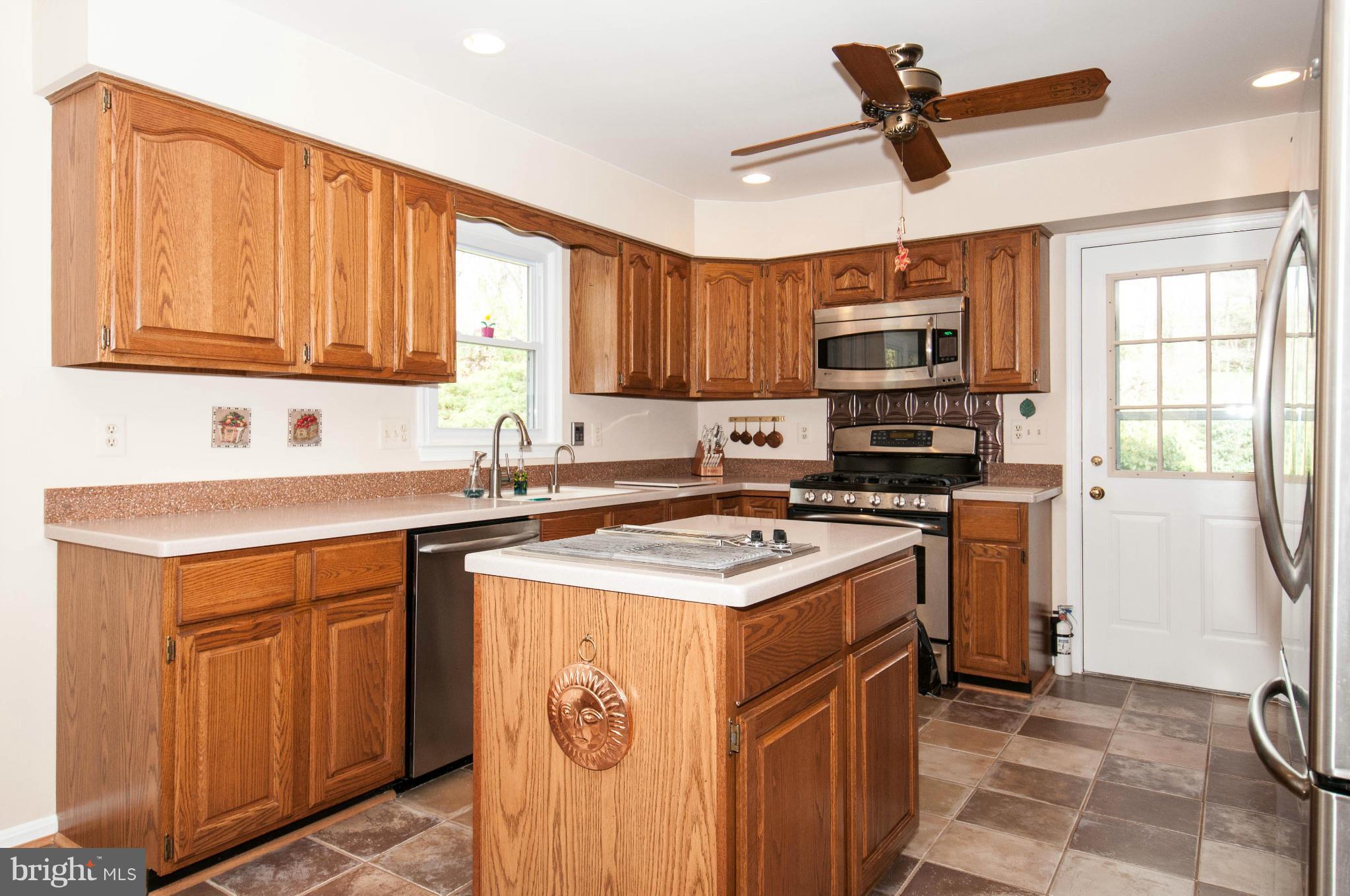 11662 Havenner Road Fairfax Station, VA 22039 - Photo 16 of 30 a kitchen with a stove a sink and a refrigerator
