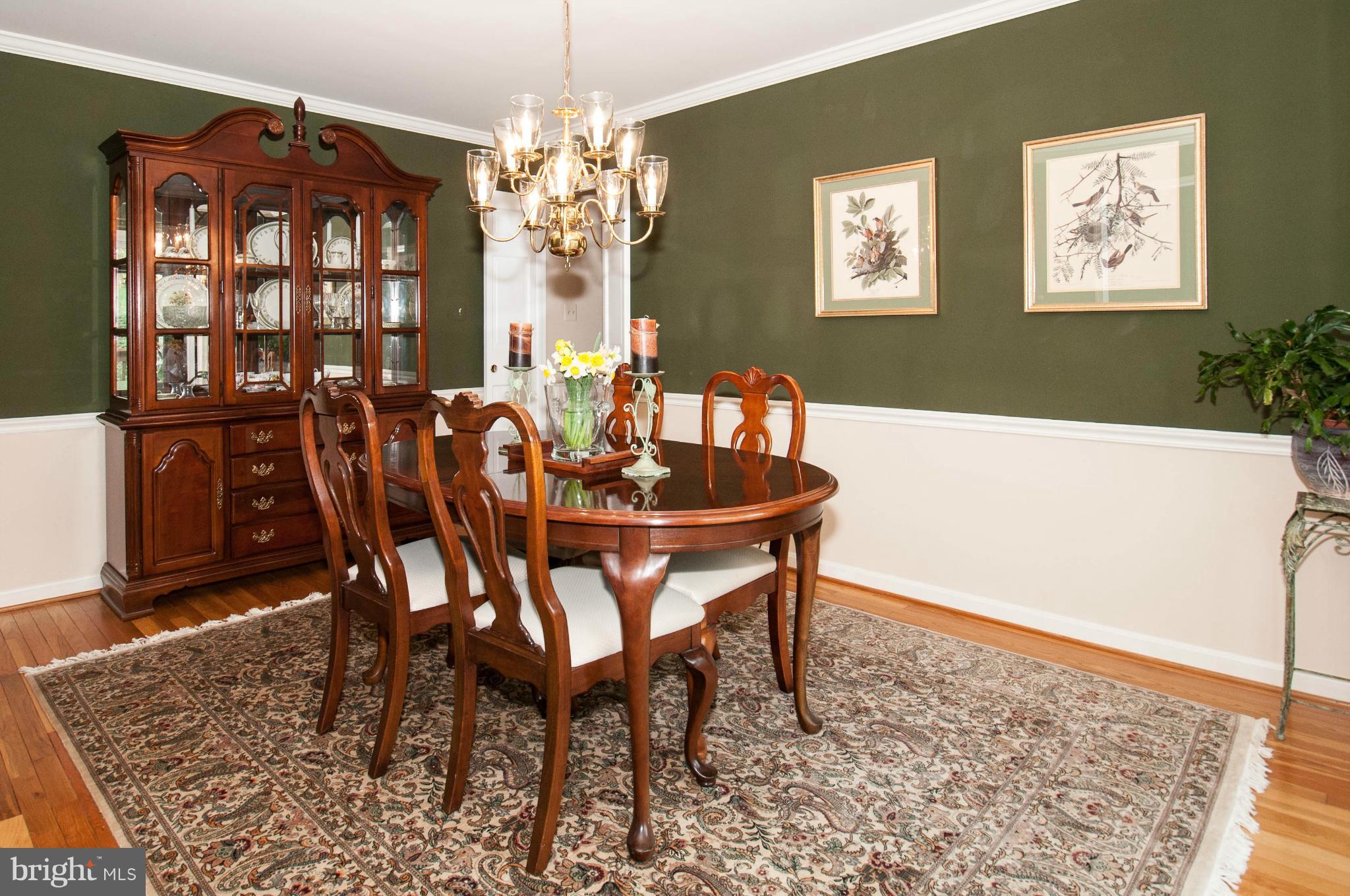 11662 Havenner Road Fairfax Station, VA 22039 - Photo 18 of 30 a dining room with furniture a rug and a chandelier