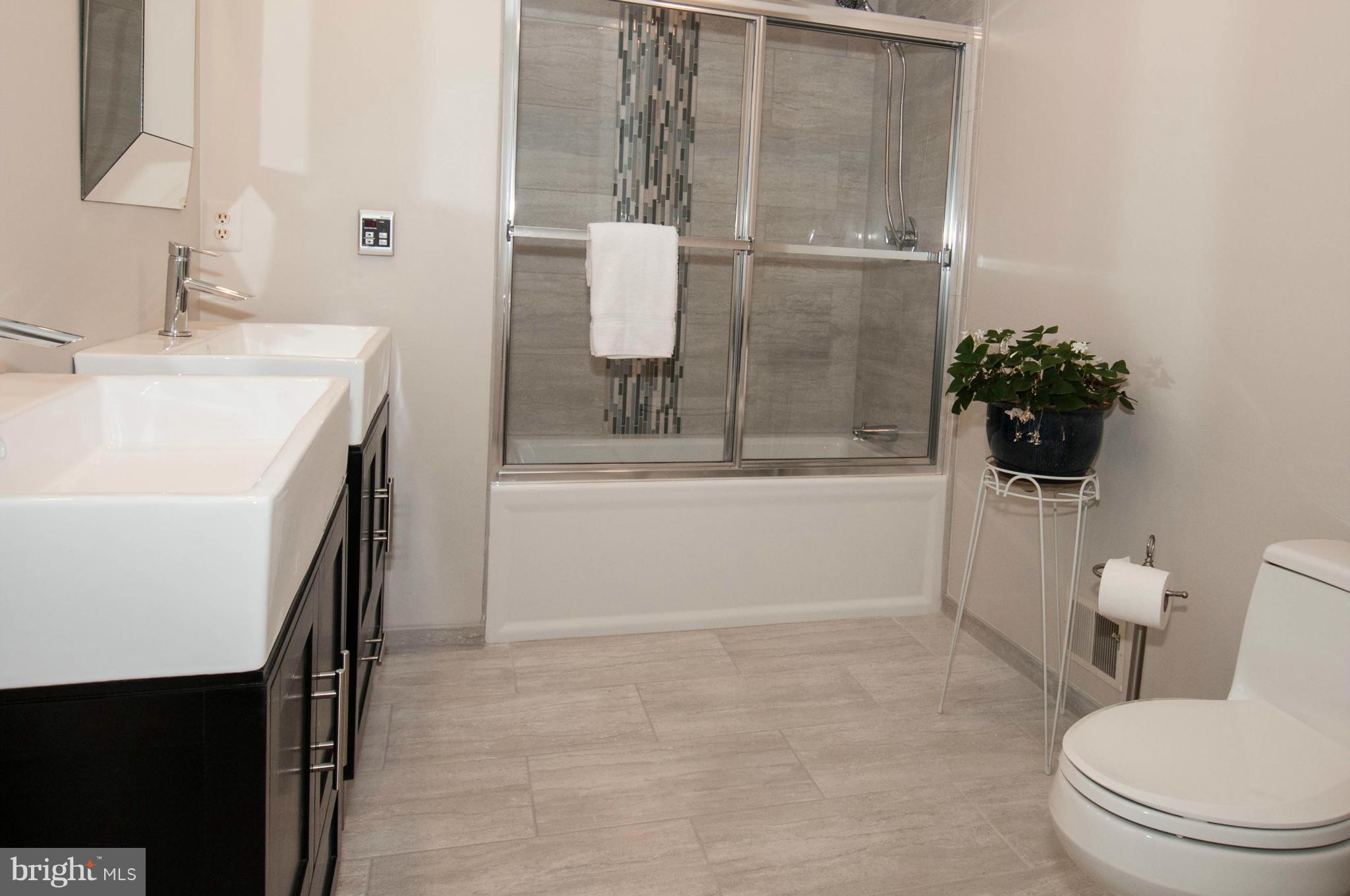 11662 Havenner Road Fairfax Station, VA 22039 - Photo 19 of 30 a bathroom with a sink a toilet and shower