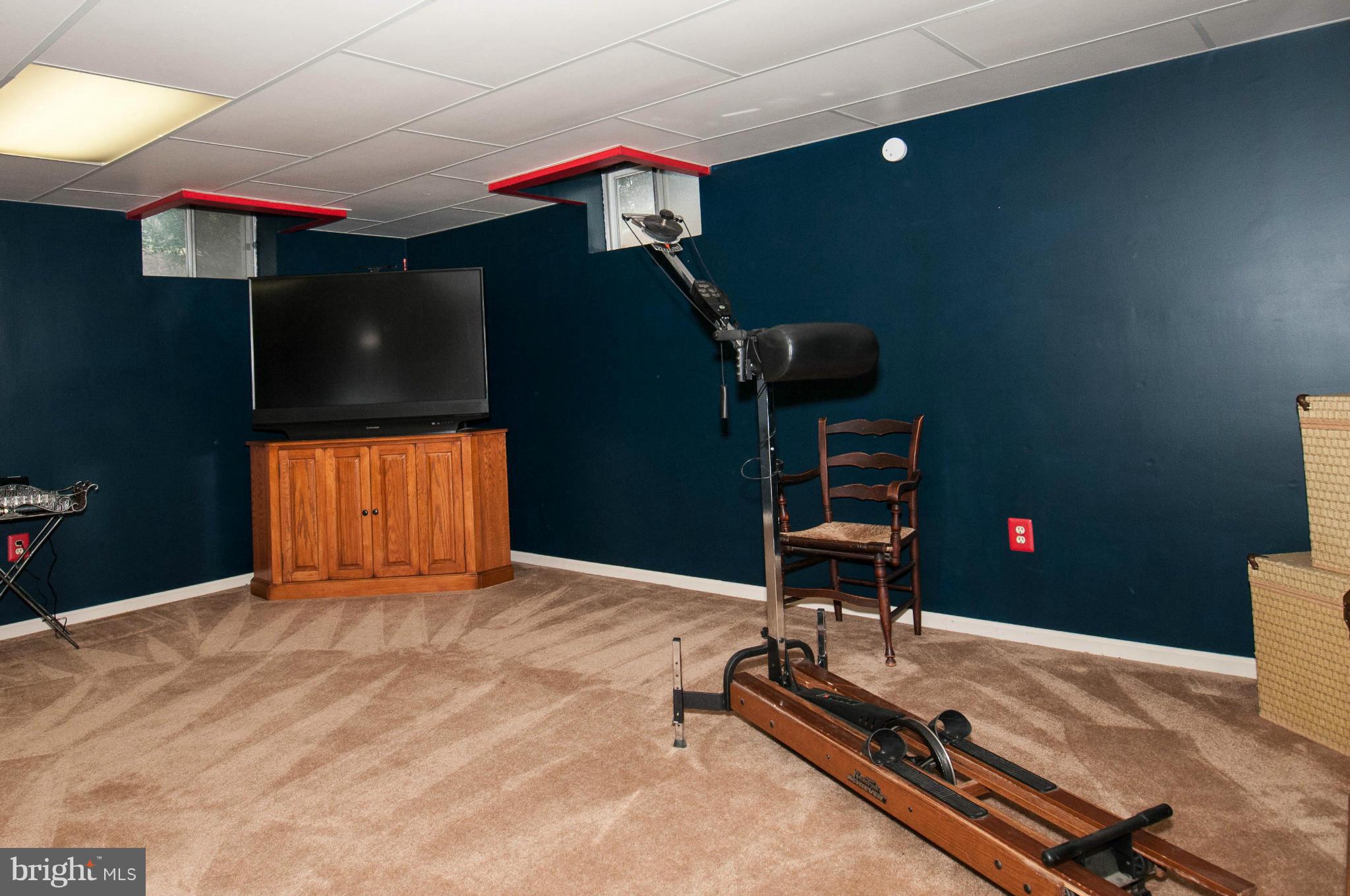 11662 Havenner Road Fairfax Station, VA 22039 - Photo 28 of 30 a bedroom with a bed and gym equipment