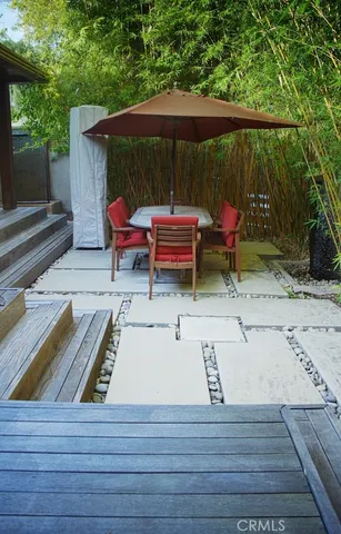 a view of a backyard with chairs and a tree
