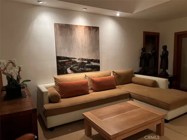 a living room with furniture and a book shelf