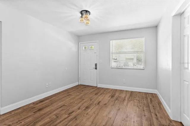 wooden floor in an empty room with a window