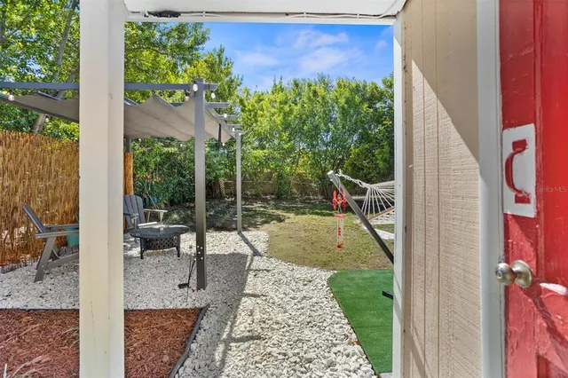 a view of a backyard with sitting area