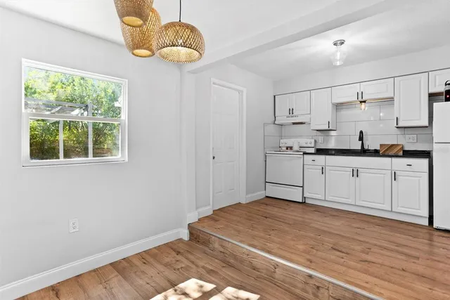 a kitchen with a sink cabinets and window