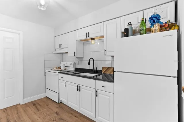 a kitchen with stainless steel appliances a sink and a refrigerator