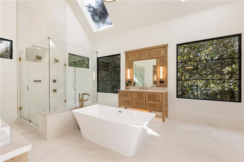 388 Londonberry Road Northwest Sandy Springs, GA 30327 - Photo 33 of 84 a bathroom with a tub a sink and a large mirror
