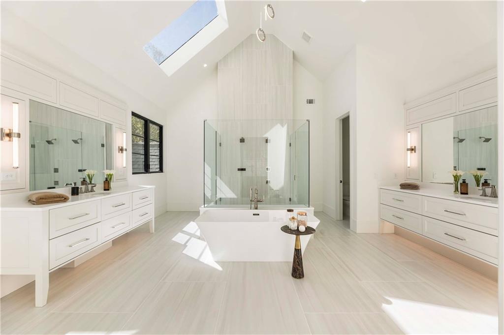 388 Londonberry Road Northwest Sandy Springs, GA 30327 - Photo 41 of 84 a large white bathroom with a tub sink and mirror