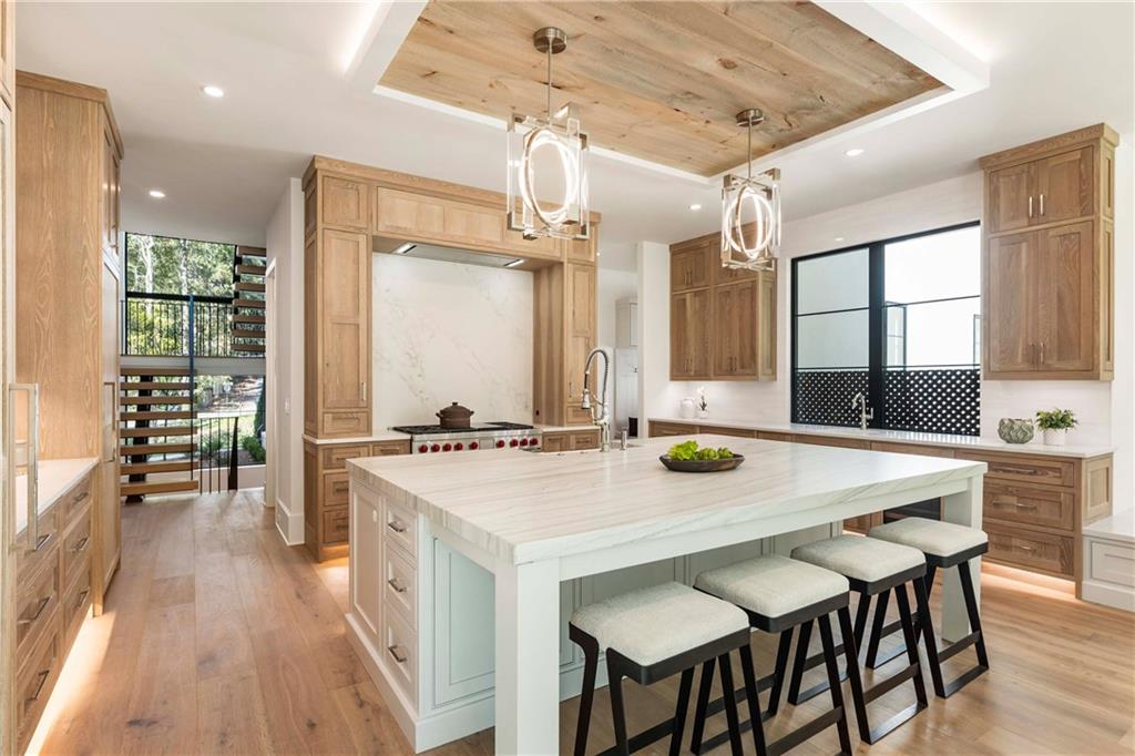 388 Londonberry Road Northwest Sandy Springs, GA 30327 - Photo 5 of 84 a kitchen with a table chairs and wooden floor