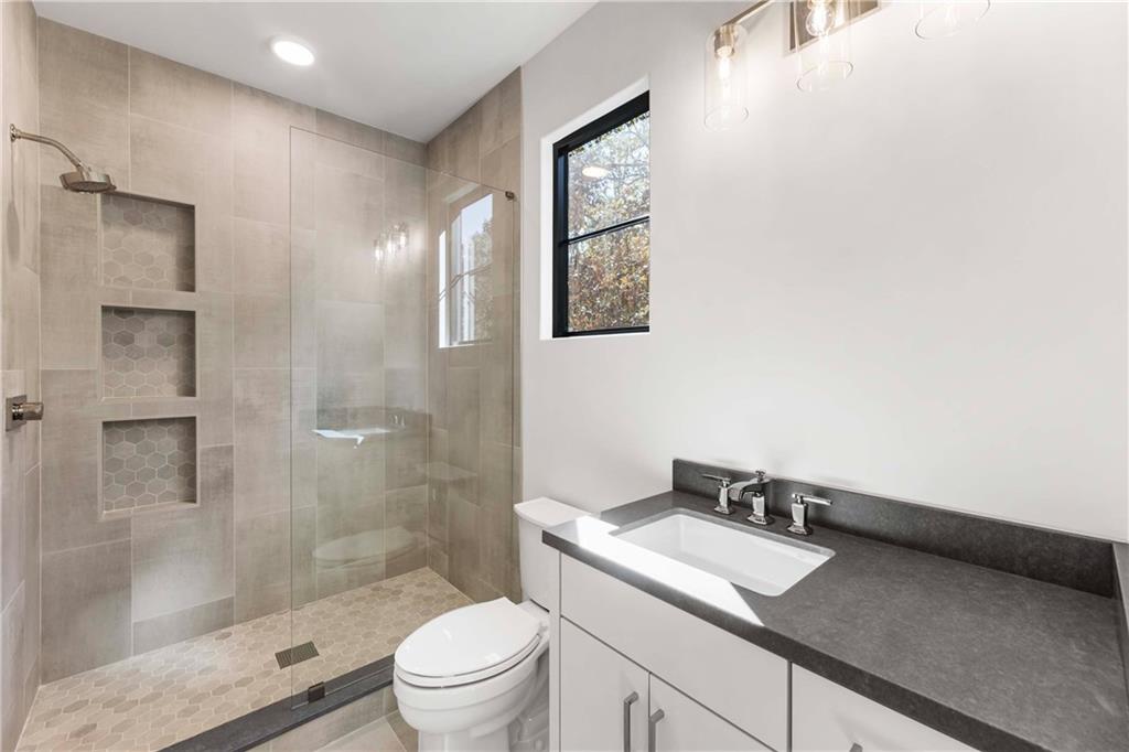 388 Londonberry Road Northwest Sandy Springs, GA 30327 - Photo 52 of 84 a bathroom with a granite countertop sink a toilet and shower