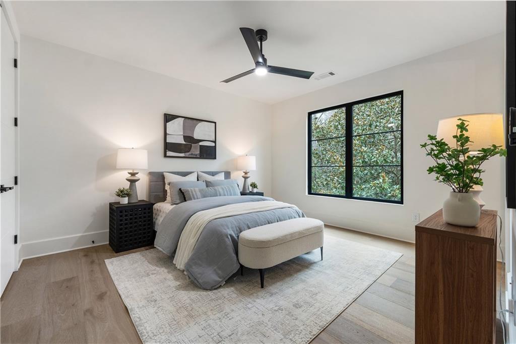 388 Londonberry Road Northwest Sandy Springs, GA 30327 - Photo 53 of 84 a spacious bedroom with a bed and a potted plant