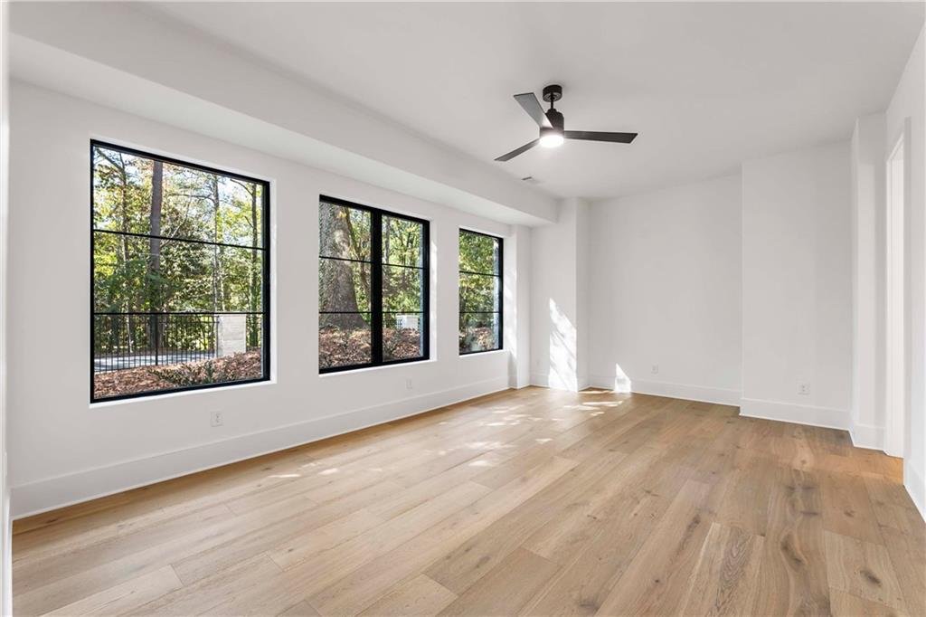 388 Londonberry Road Northwest Sandy Springs, GA 30327 - Photo 60 of 84 a view of an empty room with wooden floor and a window