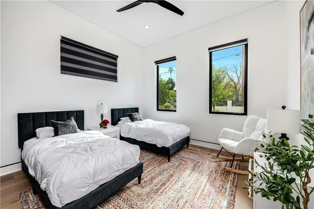 a bedroom with two beds and a large window