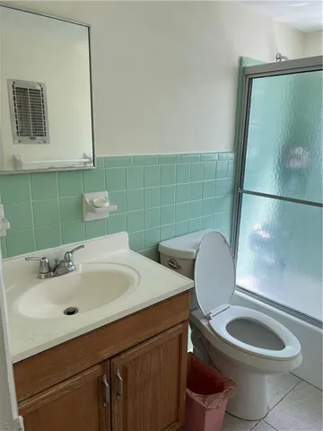 a bathroom with a sink mirror toilet and bathroom
