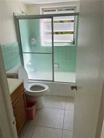 a bathroom with a toilet a sink and shower