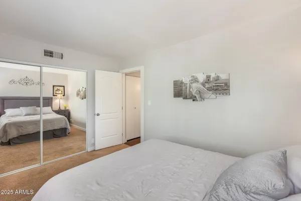 a bedroom with a bed and a lamp