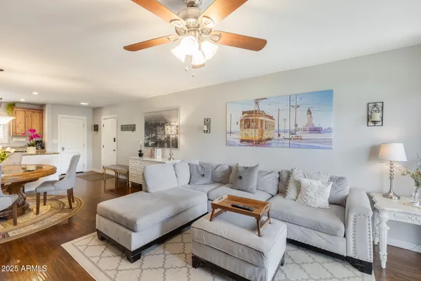 a living room with furniture and a chandelier
