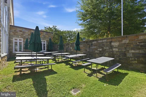 a front view of a house with a yard and outdoor seating