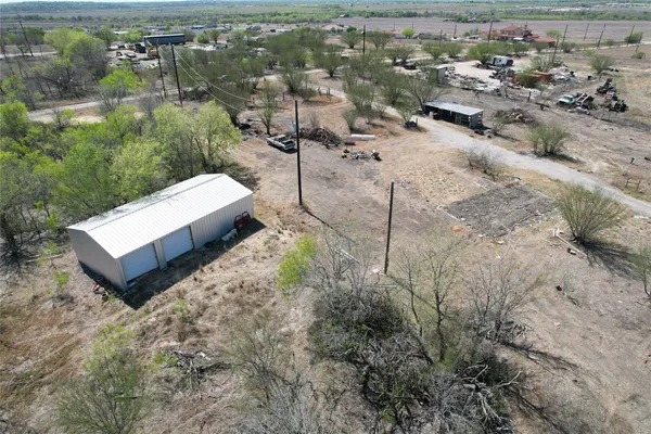 an aerial view of a house with a yard and lake view