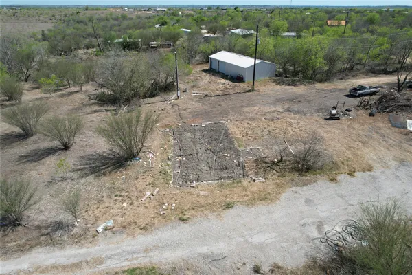 a view of a backyard with table and chairs with wooden fence