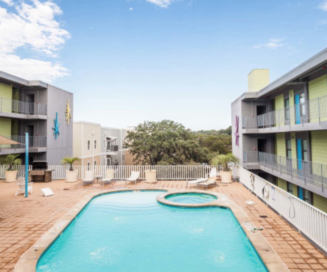 2408 Leon Street, Unit 104 Austin, TX 78705 - Photo 5 of 5 a view of residential houses with swimming pool