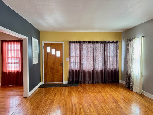 2918 Pershing Boulevard Clinton, IA 52732 - Photo 9 of 33 an empty room with wooden floor and windows