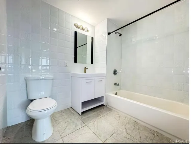 a bathroom with a toilet sink and shower