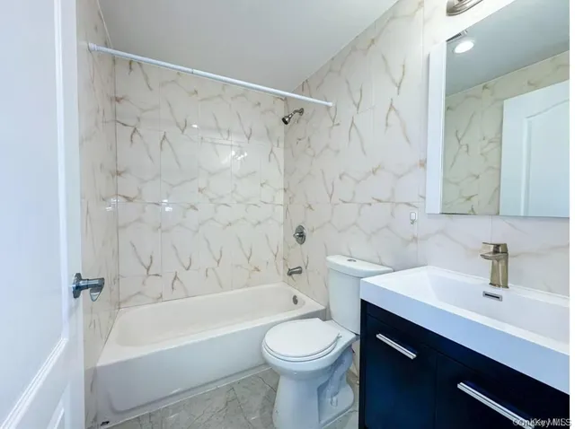 a bathroom with a sink a toilet and a bathtub