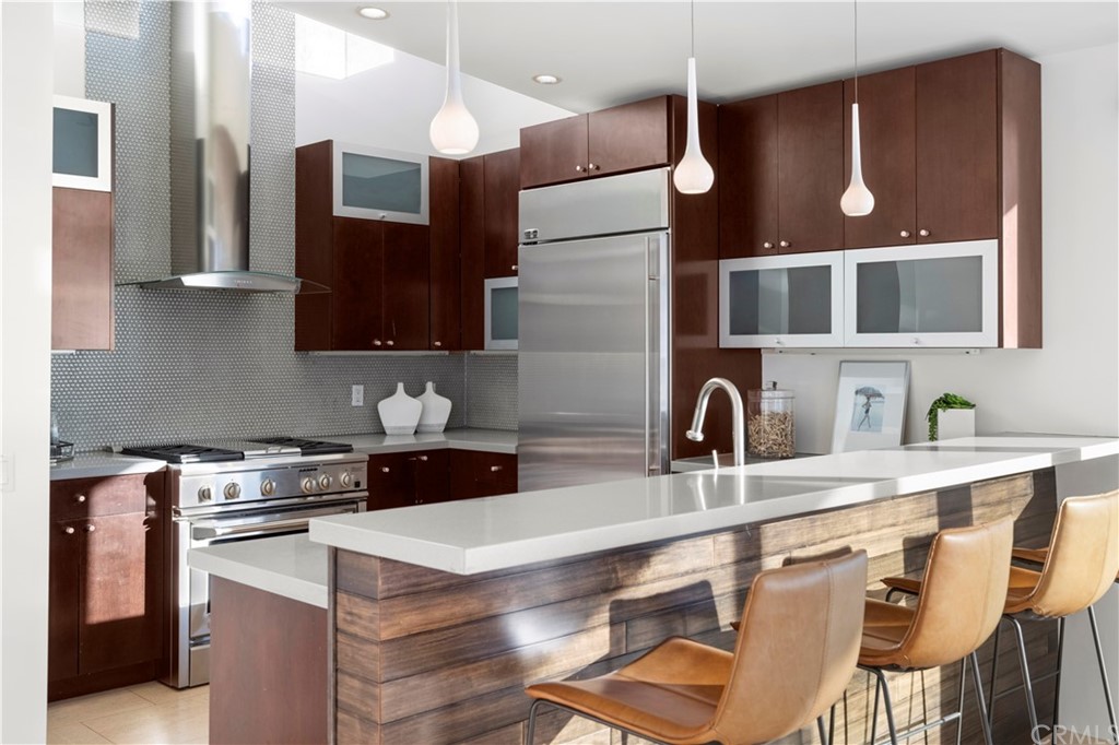 970 Baja Street Laguna Beach, CA 92651 - Photo 5 of 27 a kitchen with a sink a stove and chairs