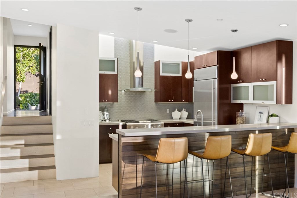 970 Baja Street Laguna Beach, CA 92651 - Photo 6 of 27 a kitchen with stainless steel appliances granite countertop a sink and a refrigerator