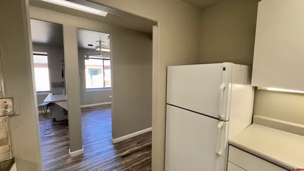 a room with a refrigerator and a sink