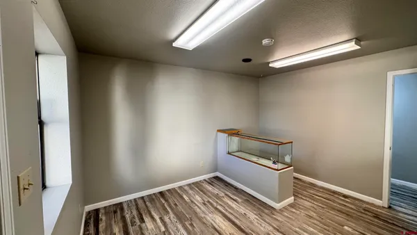 a view of a hallway with wooden floor