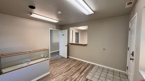 a room with a chair and a chandelier fan