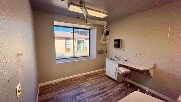 a view of a room with wooden floor and windows