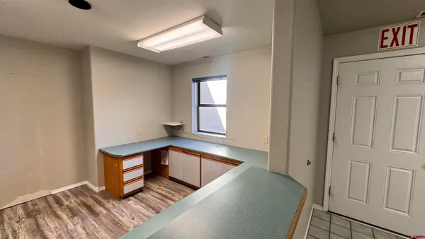 a room with wooden floor and window