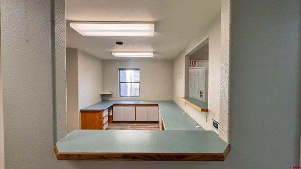 a room with wooden floor and windows