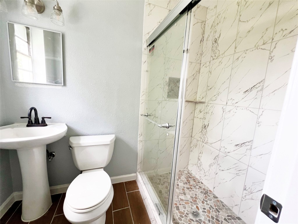 103 Cosmos Street, Unit 4 Houston, TX 77009 - Photo 5 of 8 a white toilet sitting next to a bathroom sink