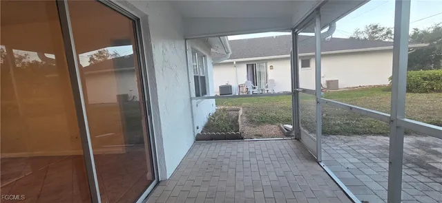 a porch with a glass door shower and hardwood floor