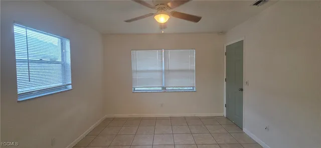 an empty room with closet and windows