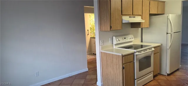 a kitchen that has a sink and a stove