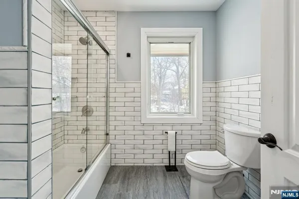 a bathroom with a toilet a sink and a window