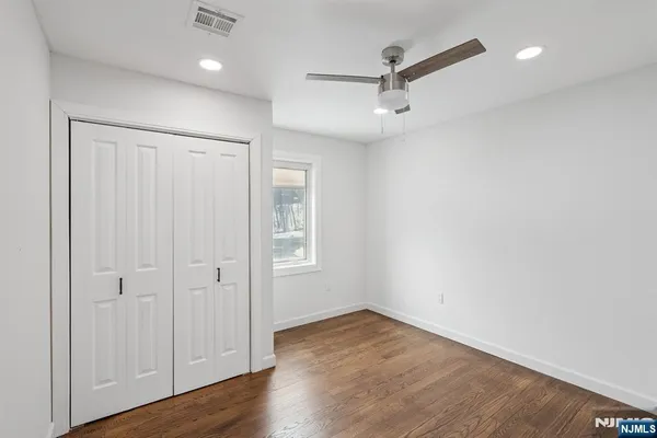 a view of a room with window wooden floor and a ceiling fan