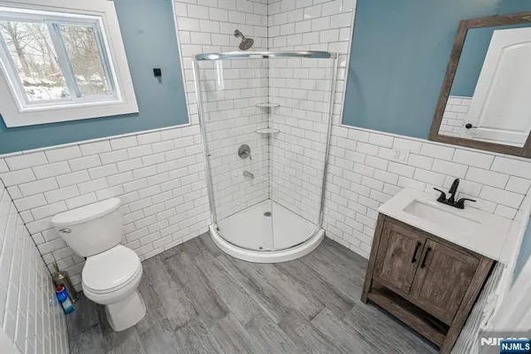 a kitchen that has a sink and a stove with wooden floor