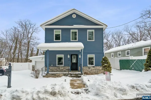 a view of a white house with large windows